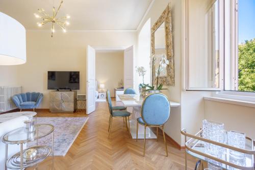 a living room with a table and chairs at James Joyce Luxury Apartment in Trieste