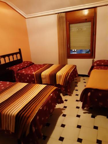 Postel nebo postele na pokoji v ubytování Hostal El Molino