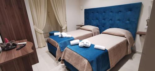 una camera d'albergo con due letti e un tavolo di Amore Napoletano a Napoli