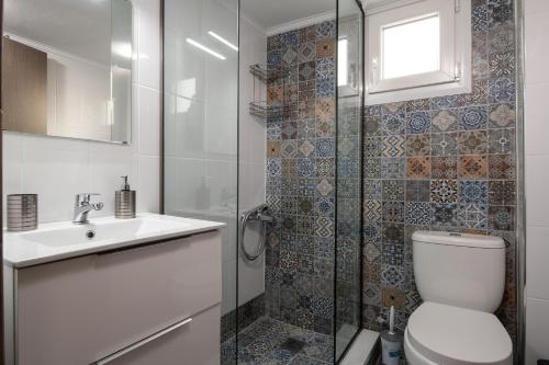 a bathroom with a shower and a toilet and a sink at mansion luxury apartment in Psakoudia