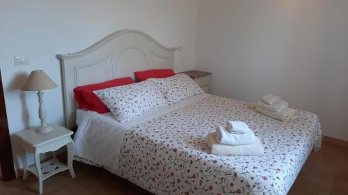a bedroom with a bed with two towels on it at Oasi Del Verde in Soriano nel Cimino