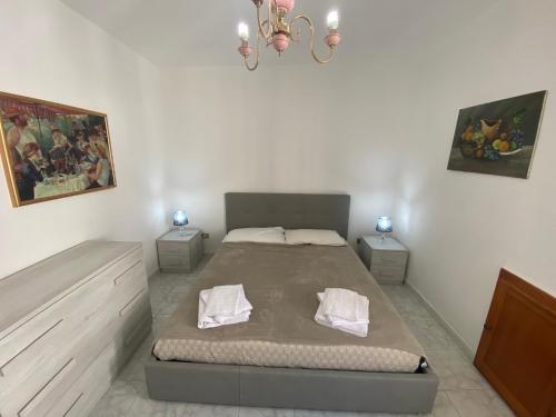 a bedroom with a large bed with two night stands at Dorgali Apartment La Marmora in Dorgali