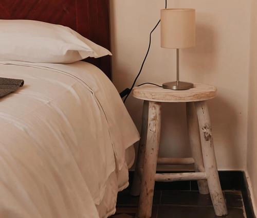 a table with a lamp on it next to a bed at Angilina's apartment in Vernazza