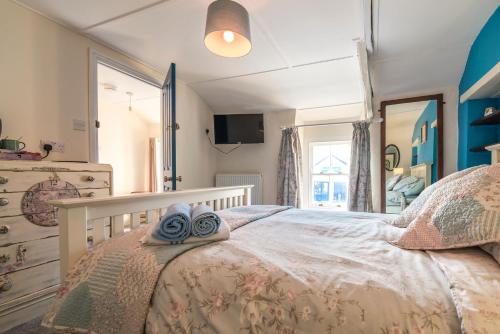 a bedroom with a bed with towels on it at Manorbier Castle Inn Bay Room in Manorbier