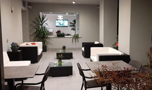 a living room with couches and tables and a tv at Garda Life in Riva del Garda