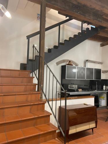 a staircase in a room with a kitchen at Loft Ponte Pietra in Verona