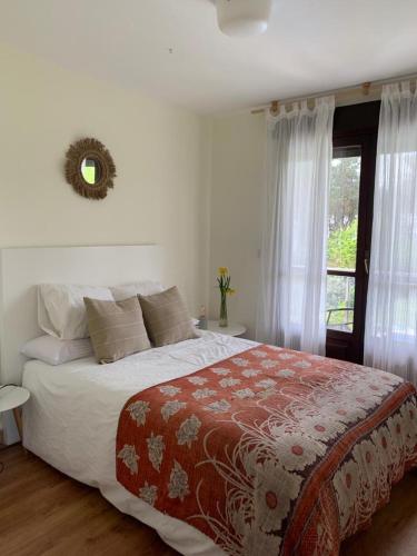 a bedroom with a large bed and a window at Sobreomar in Bueu