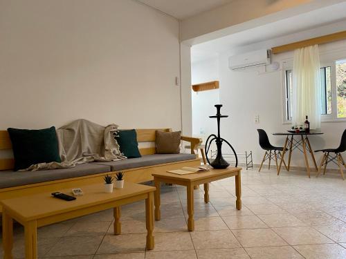 a living room with a couch and tables in it at Yiayia's House, in Zipari Village "1" in Zipárion
