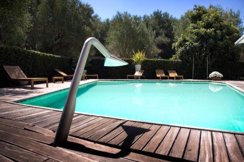 a swimming pool with a slide on a wooden deck at Hotel Le Piane in Villammare