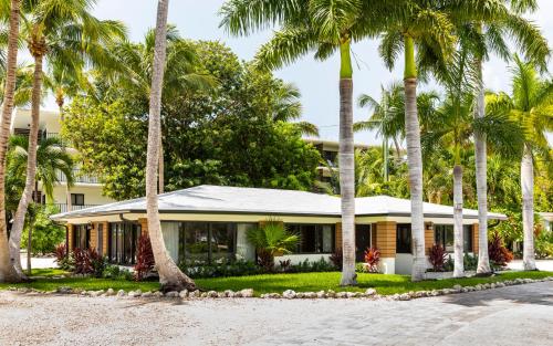 a house with palm trees in front of it at La Siesta Resort & Villas in Islamorada