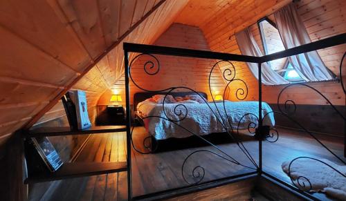 a bedroom with a bed in a wooden room at Brvnare Platan - prirodna oaza in Vrdnik