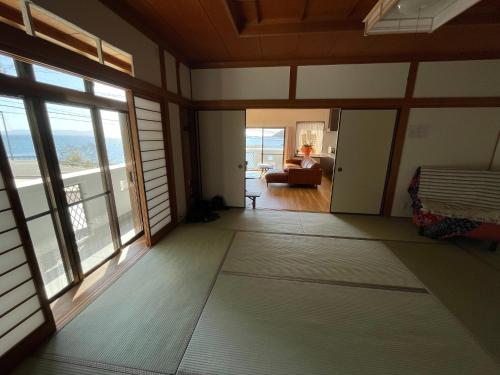 a living room with large windows and a couch at Coast house Nabura - Vacation STAY 29534v in Nagasaki