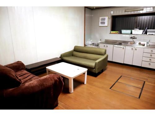 a living room with a couch and a coffee table at Guest House Kushimoto - Vacation STAY 31002v in Kashino