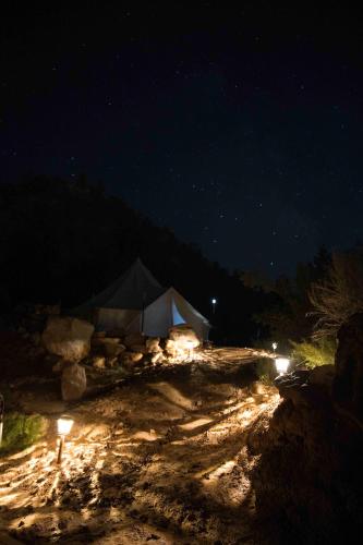 a tent in the middle of a field at night at Zion View Camping in Hildale