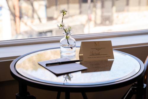 a table with a glass vase with a sign on it at Mossbrae Hotel in Dunsmuir