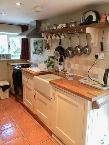 a kitchen with a sink and a counter top at Culloden Farmhouse in Camelford