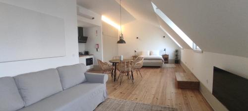 a living room with a couch and a table at Venezapartments in Aveiro