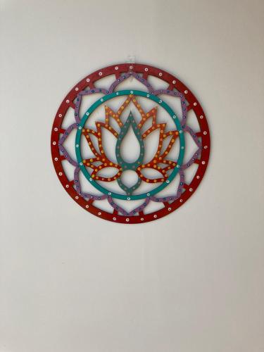 a red and white plate hanging on a wall at Valle Luna in Tocaima