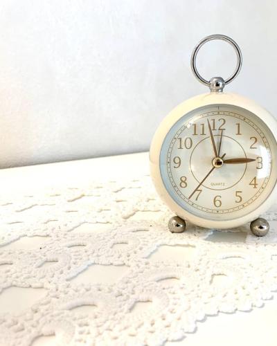 a clock sitting on top of a bed at La Vista del Poggio in Castellaro