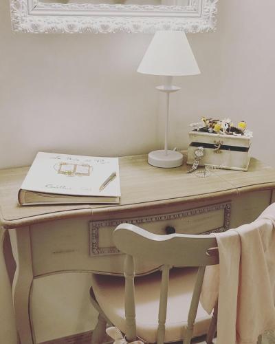 a desk with a lamp and a book on it at La Vista del Poggio in Castellaro