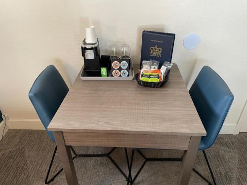a table with two blue chairs and a box of drinks at Crown Motel in Kings Beach