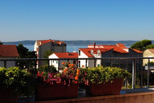 a balcony with pots of plants and a city at Apartment Silvia in Kaštela
