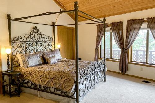 a bedroom with a metal canopy bed in a room with windows at Sedona Serenity in Sedona