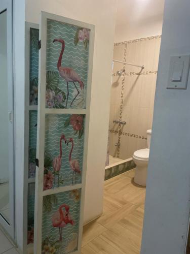 a bathroom with a shelf with pink flamingos on it at VillaMobay in Montego Bay