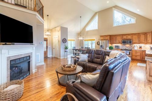 a living room with leather furniture and a fireplace at Mountain-View Hideaway in Waynesville