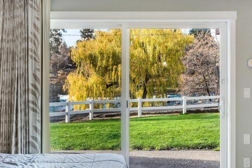 a sliding glass door with a view of a fence at Bend Riverside Condos Near Downtown Bend in Bend