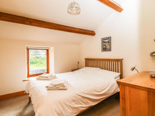 En eller flere senge i et værelse på Kestrel Cottage