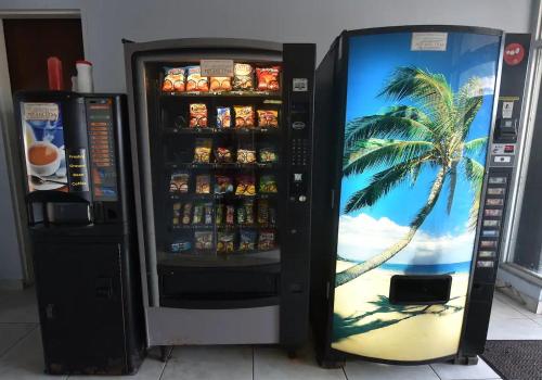 a soda machine with a picture of a palm tree at KASA El Sol by the Sea with Pool and Parking in San Juan