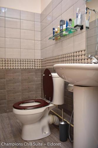 a bathroom with a toilet and a sink at Champions Chill Suite in Eldoret