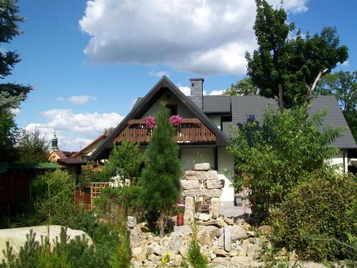 a house with a deck and a yard at Stara Kuźnia in Sosnówka