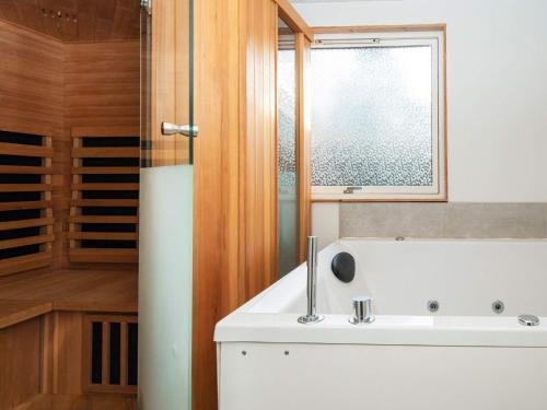 a bathroom with a white sink and a window at 5 person holiday home in Knebel in Knebel