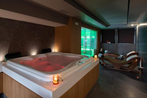 a large bathroom with a red bath tub at Gold Tower Lifestyle Hotel in Naples