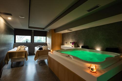 a large bathroom with a green tub in it at Gold Tower Lifestyle Hotel in Naples
