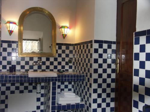 a bathroom with a sink and a mirror at Dar Ness in Essaouira