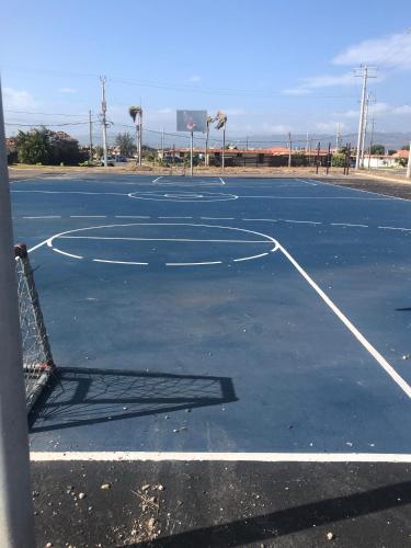 an empty basketball court with a basketball hoop at Bayfront Villa & Apartment in Portmore