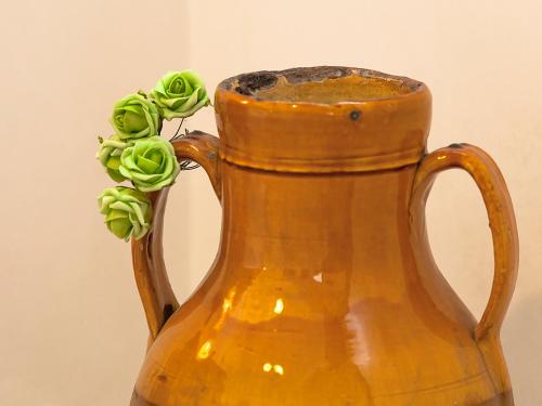 a yellow vase with a plant in it at Coppola di Seta in Locorotondo