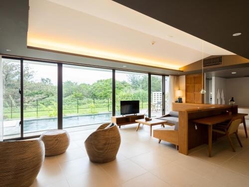 a living room with a table and a large window at The Rescape in Miyako-jima