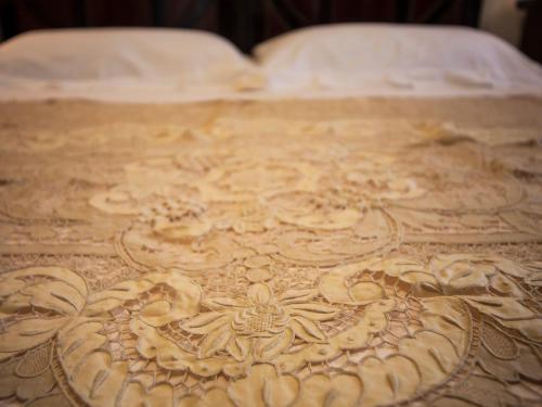 a wooden table with a design on top of a bed at Coppola di Seta in Locorotondo