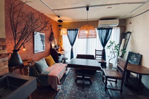 a living room with a couch and a table at TOE LIBRARY Tokyo Asakusa in Tokyo