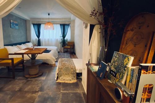 a hotel room with a bed and a table at TOE LIBRARY Tokyo Asakusa in Tokyo