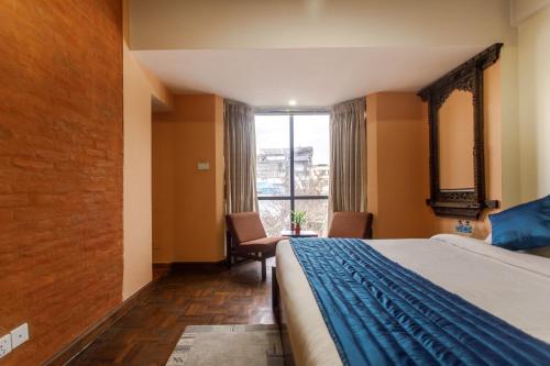 a hotel room with a bed and a window at Gaju Suite Hotel in Kathmandu