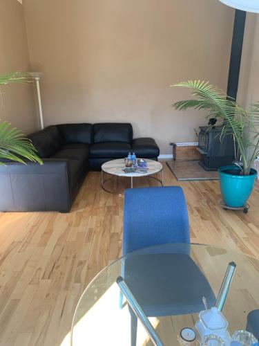 a living room with a couch and a glass table at Salish B&B and Spa in West Kelowna