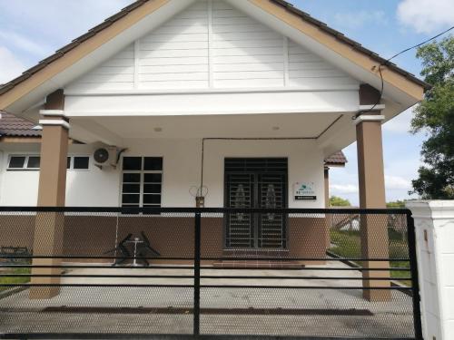 a house with a gate in front of it at Simple Home by Aimie Fully Aircond in Dungun