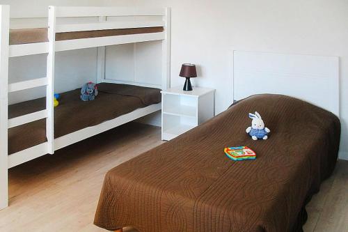 a bedroom with two bunk beds and a bed with a book at Apartment in Grandcamp for 4 Person in Grandcamp-Maisy