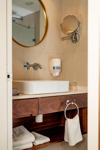 a bathroom with a sink and a mirror at Montefiore Hotel By Smart Hotels in Jerusalem