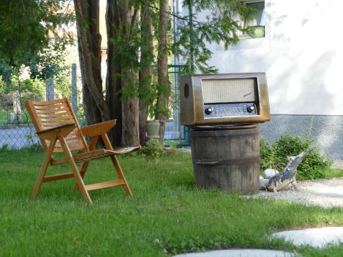 a radio sitting on top of a trash can next to a chair at House 1797 - Charm of Slovenian Vintage in Dob